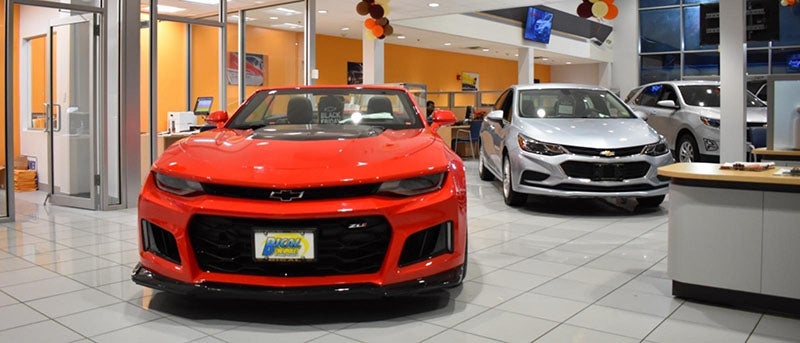 Dealership showroom with multiple vehicles in sight